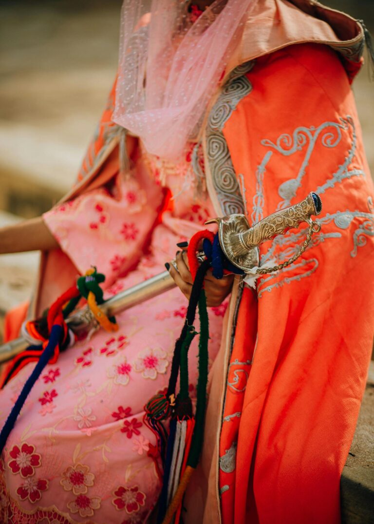 A vibrant display of ornate traditional clothing and a decorative sword.