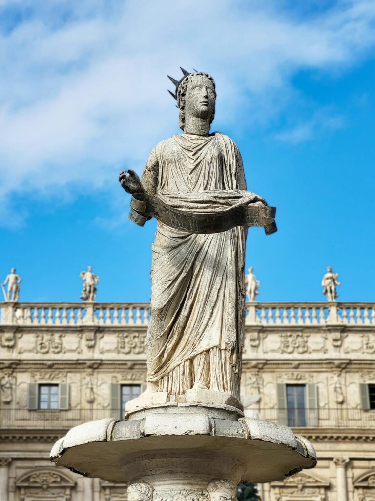 Majestic statue in Piazza delle Erbe, Verona, with historical architecture in the background.